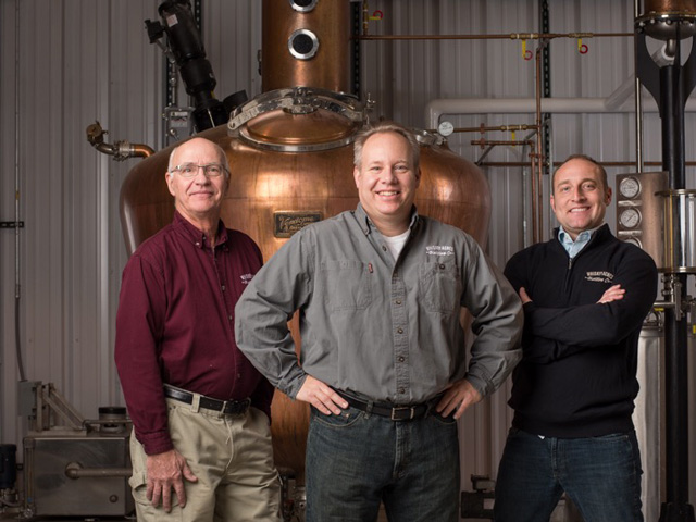 From left, Jim Walter, farmer and co-owner of Whiskey Acres Distilling Company; Jamie Walter, president and CEO of the company; and Nick Nagle say the sanitizer project has become important to their employees who want to help Americans get through this virus emergency. (Photo courtesy of Whiskey Acres Distilling Company)